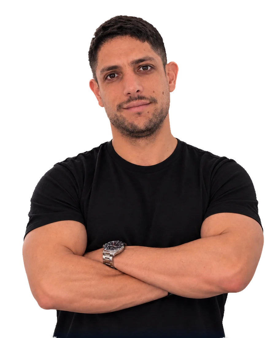 Juan Pablo Tagliaferro, arms folded, in a black t-shirt against a dark ground.